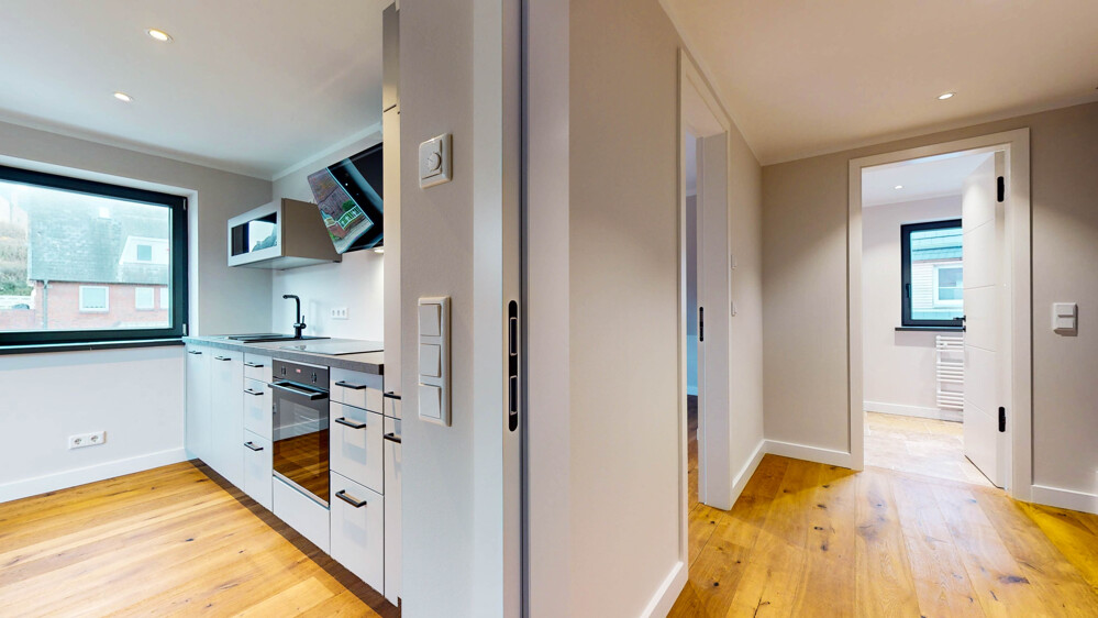 Hochwertige Neubauwohnung in strandnaher Lage mit Südbalkon - Titelbild